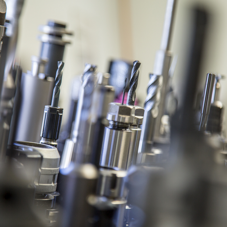 Assortment of CNC machine tools including end mills, spot drills and reamers for high precision cutting.
